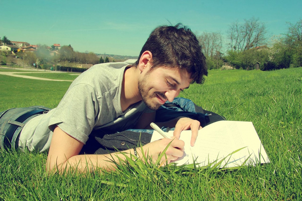 Building-Passion-Man-writing-in-grass